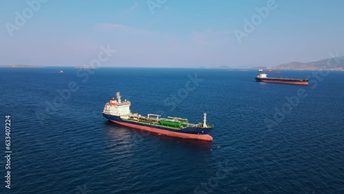 Oil chemical tanker ship anchored in sea industrial port area, aerial wide shot