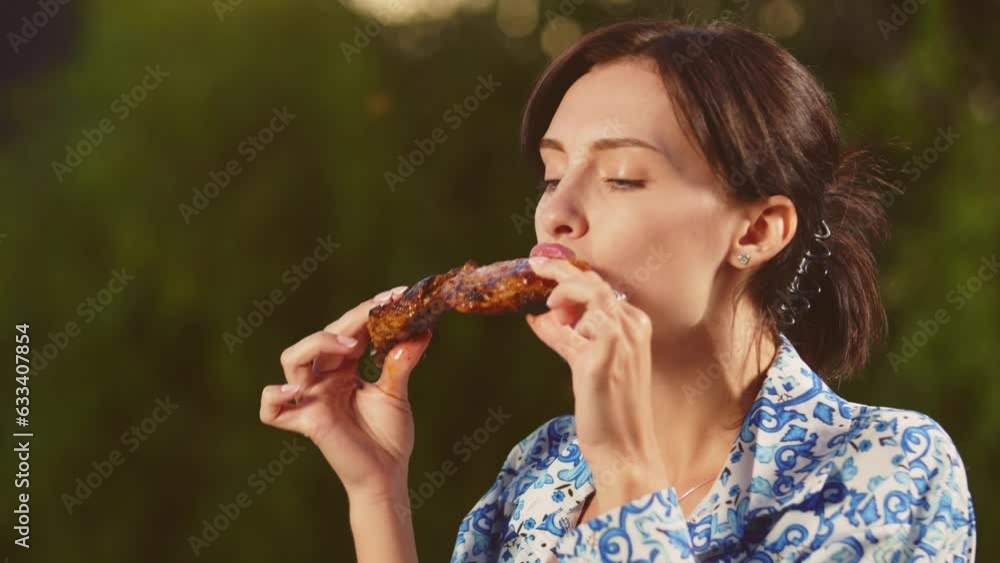 people, diet, cooking and nutrition concept - hungry young woman eating meat in nature people, diet, cooking and nutrition concept - hungry young woman eating meat in nature