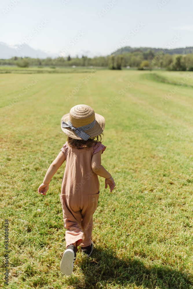 Carefree girl running in countryside field