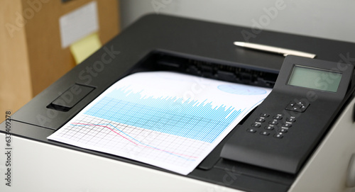 Close-up on special high-tech fax printing significant charts and graphs in office. Pile of documents used to analyze successful corporation investment. Reports sale concept
