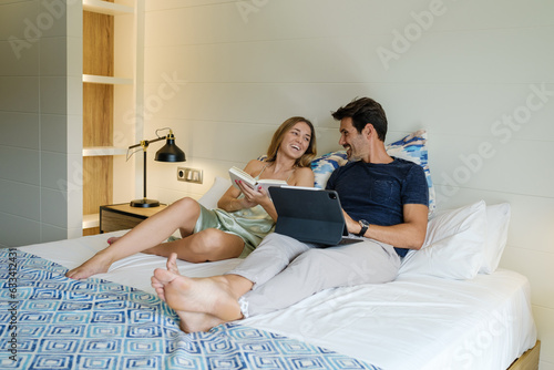 Couple spending time together on bed at home