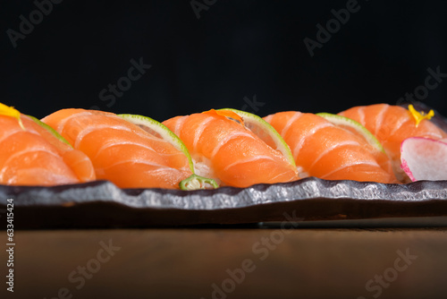 Appetizing nigiri sushi with salmon on tray