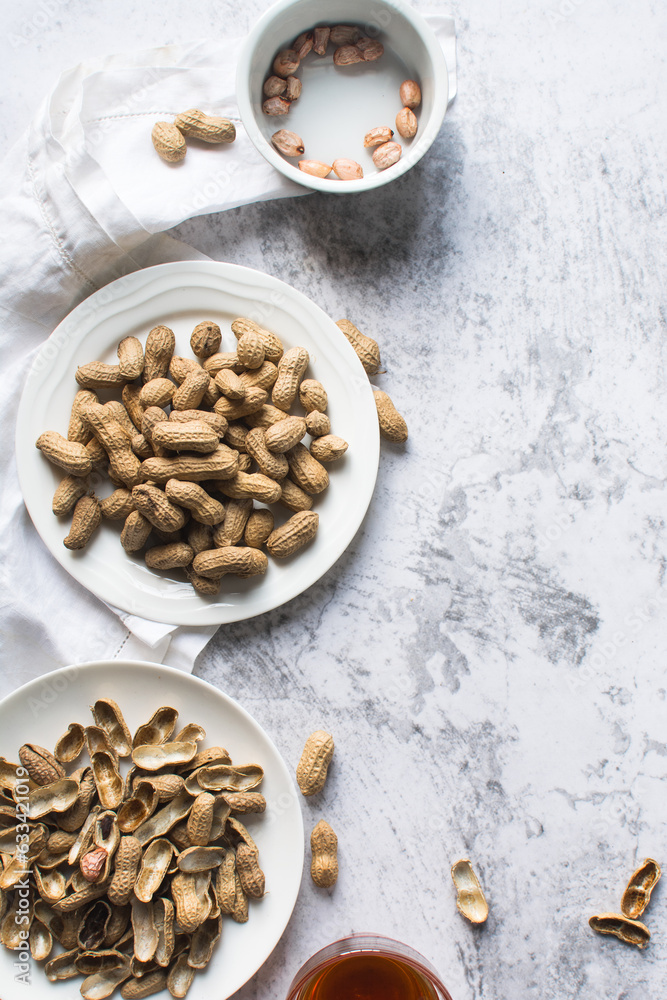Top view of shelled groundnut in a plate, flatlay of shelled peanut in a plate on a marble countertop, nigerian roasted groundnut in a bowl Top view of shelled groundnut in a plate, flatlay of shelled peanut in a plate on a marble countertop, nigerian roasted groundnut in a bowl