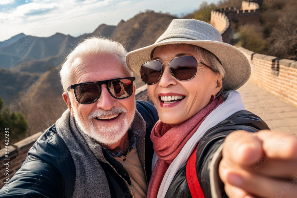 A happy elderly tourist couple take a selfie in China with the Great Wall in the background. Travel retirement concept. AI generated.