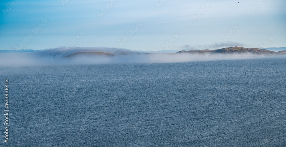 Beautiful view of the sea with a strip of fog from the tundra coast