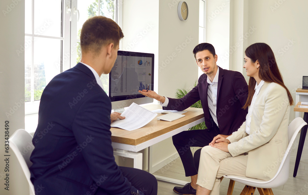 Business people team working at office discussing stats financial data on pc computer screen with diagram, charts sitting on workplace. Employees or staff analyzing company on meeting. Business people team working at office discussing stats financial data on pc computer screen with diagram, charts sitting on workplace. Employees or staff analyzing company on meeting.