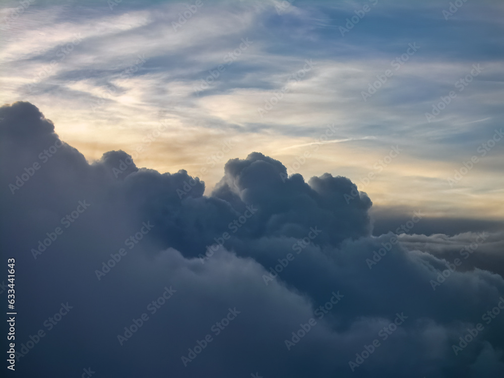 A cloudy sky with a sunset in the background, as seen from an airplane. A cloudy sky with a sunset in the background, as seen from an airplane.