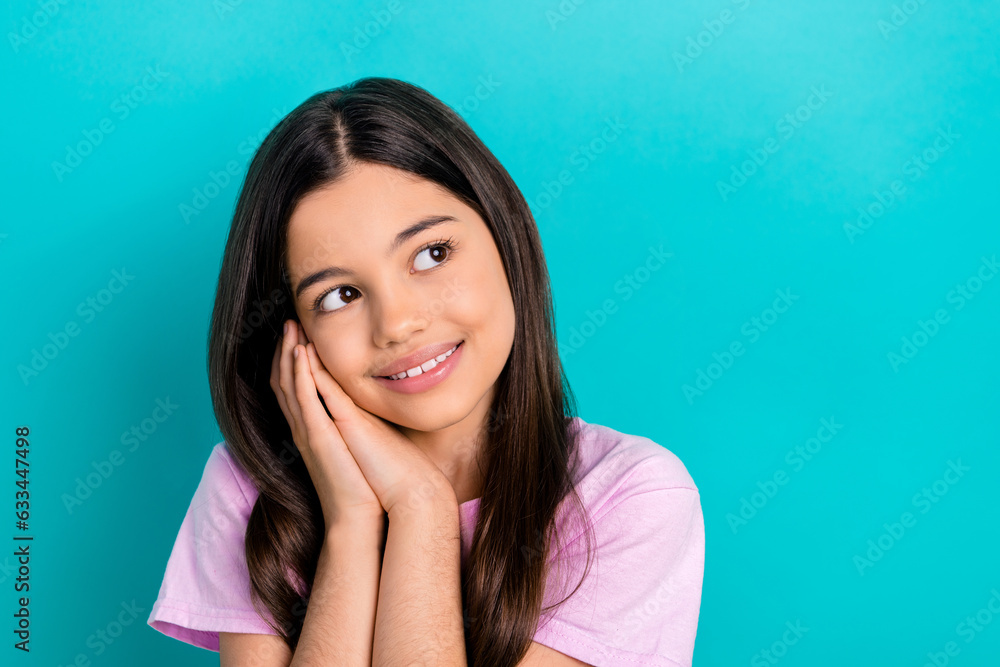 Portrait of cute dream schoolgirl kid preteen hands touch cheek looking empty space want find boyfriend isolated on cyan color background Portrait of cute dream schoolgirl kid preteen hands touch cheek looking empty space want find boyfriend isolated on cyan color background