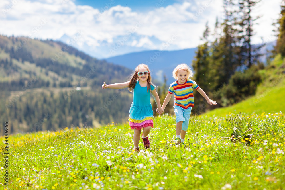 Children hiking in Alps mountains. Kids outdoor.