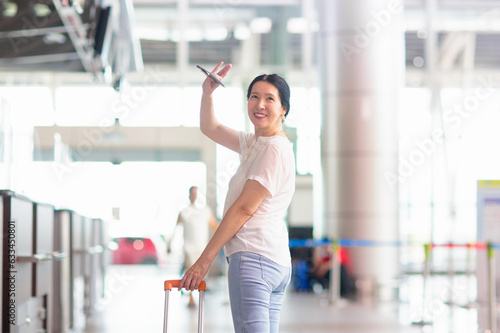 Young Asian woman in airport. Travel by air.