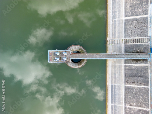 Obraz na płótnie aerial drone view of concrete wall of hydro dam with pump on the lake