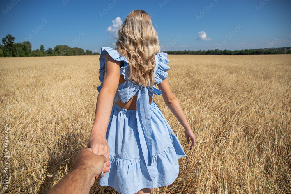 Follow me, young beautiful blonde woman in wheat field Follow me, young beautiful blonde woman in wheat field