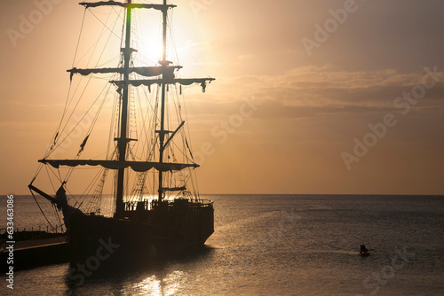 Silhouette of tall ship and people enjoying twilight, George Town, Cayman Islands, Caribbean