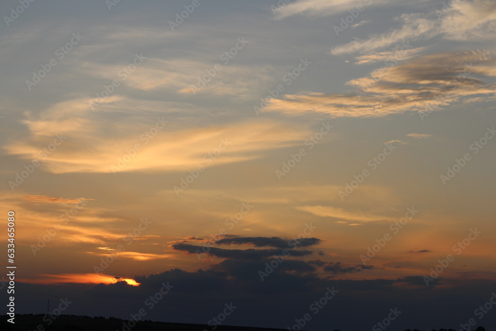 A sunset with clouds in the sky