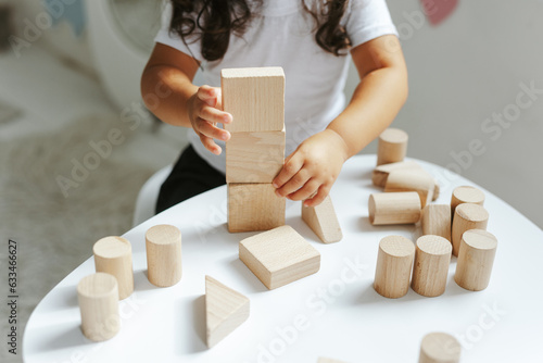 children play with wooden toys in the children's room
