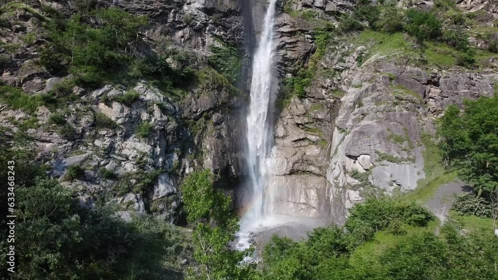 Aerial drone view of big hight alpine waterfall called Cascata Di Novalesa, Italian Alps, Piemonte, Italy. Powerful stream of water is falling down between rocky slopes covered with forest Aerial drone view of big hight alpine waterfall called Cascata Di Novalesa, Italian Alps, Piemonte, Italy. Powerful stream of water is falling down between rocky slopes covered with forest