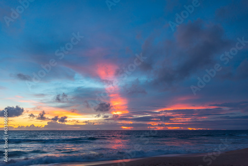 Scene of colorful pink light trough in the sky above the ocean..Scene of colorful red light trough in the dark blue sky..Gradient color. Sky texture, abstract nature background. © Narong Niemhom