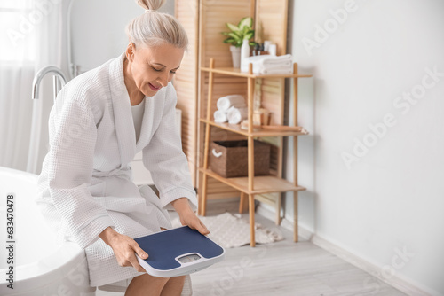 Mature woman with scales in...