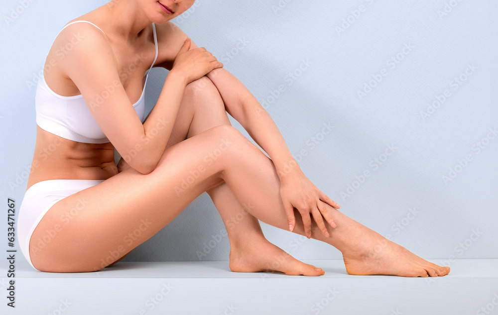 Beautiful slim woman in white underwear on grey background Beautiful slim woman in white underwear on grey background