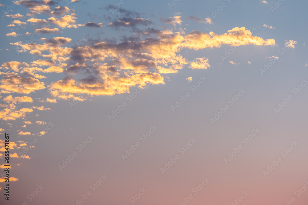 Sunset sky with golden clouds. Nature sky background.
