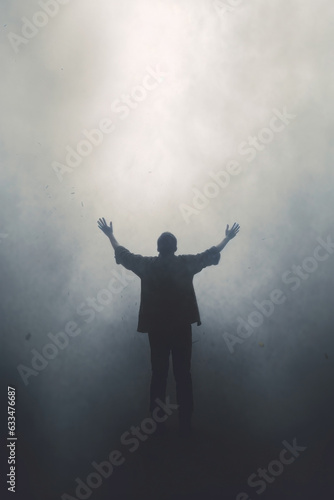 man praying with his arms raised. silhouette. religious concept. asking for divine help.