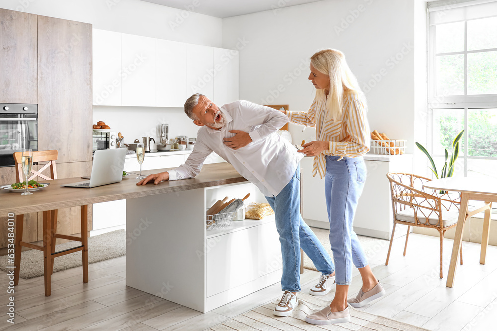 Mature woman and her husband having heart attack in kitchen Mature woman and her husband having heart attack in kitchen