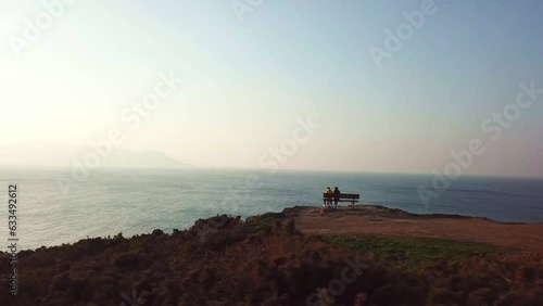 Couple sitting on the most beautiful bench in the world. photo