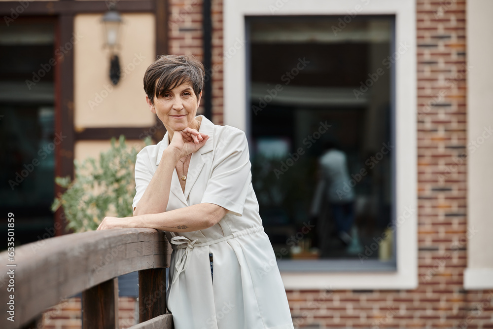 senior woman looking at camera, smiling, portrait, aging population, elderly joy, blurred