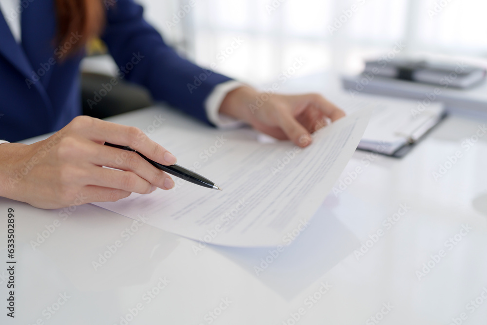 Lawyer preparing to sign a contract reading documents at office room. Lawyer preparing to sign a contract reading documents at office room.