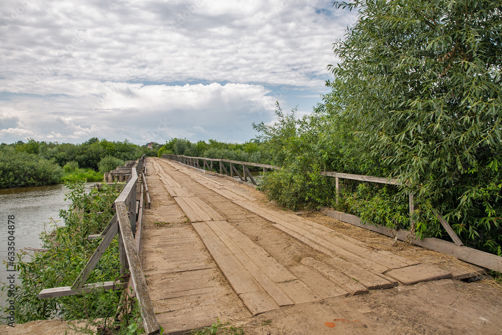 Old wooden bridge over Sluch river in Rivne region, Ukraine.