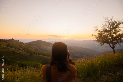 Woman travel tourist alone morning freedom and happiness. with sunset view of nature cliff mountain.