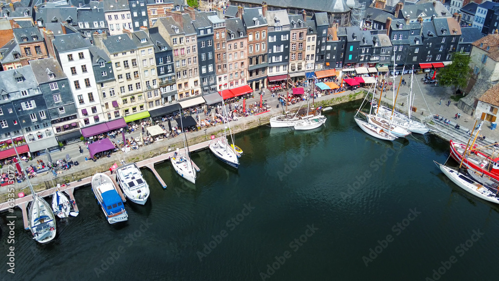 Fantastic  aerial view on Normandian Honfleut town with harbor of sailboats and fishing boats . And outdoors cafes