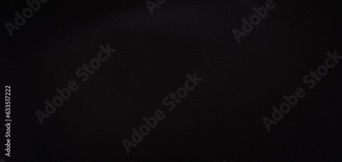 Discoloured textures on black cement surface. Soft light spots reflected on black texture photo