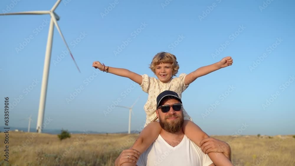 Man Carrying his Child Girl on His Shoulders and Walking in a Wind farm ...