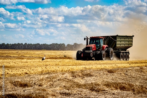 Tractor with the grain cart working on a field