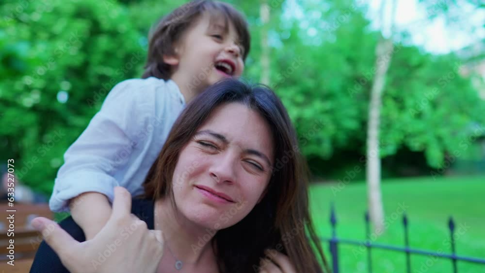 Careless small boy choking mom while playing. Kid not knowing play limits, upset mother, real life Careless small boy choking mom while playing. Kid not knowing play limits, upset mother, real life