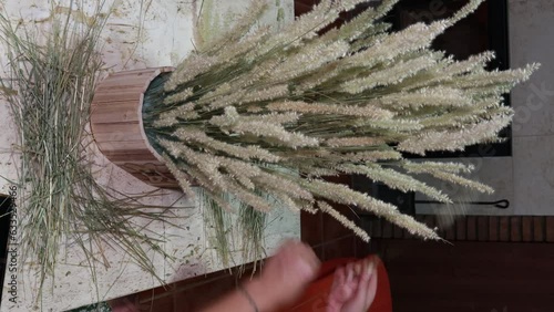 girl making arrangement of dried flowers collected from the field
