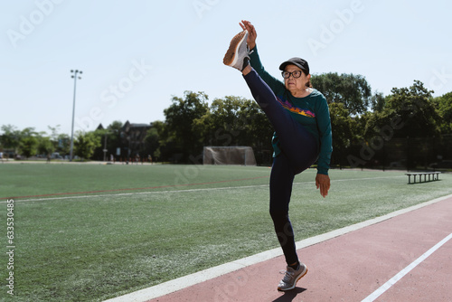 Active senior practicing sports in a running field, retirement lifestyle concept © Franco