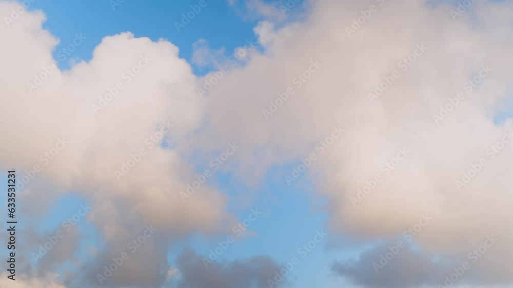 Timelapse - fast moving white fluffy clouds in the blue sky in the afternoon. Daylight, cloudy day. Cloudscape, nature, freedom and timelapse concept Timelapse - fast moving white fluffy clouds in the blue sky in the afternoon. Daylight, cloudy day. Cloudscape, nature, freedom and timelapse concept