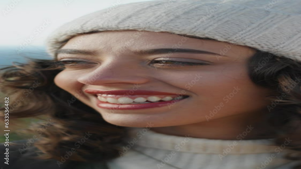 Cheerful girl looking camera on windy day vertical closeup. Happy young traveler Cheerful girl looking camera on windy day vertical closeup. Happy young traveler