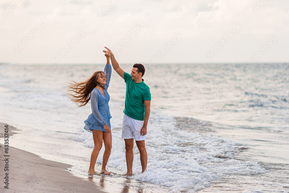 Adorable girl and happy dad having fun during beach vacation
