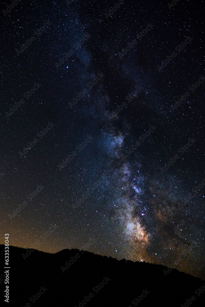 Landscape with the Milky Way and stars over the trees of a hill in the moutains Landscape with the Milky Way and stars over the trees of a hill in the moutains
