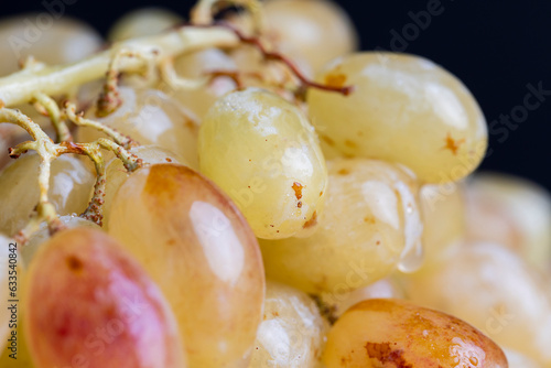 Green grapes unwashed lying on the board