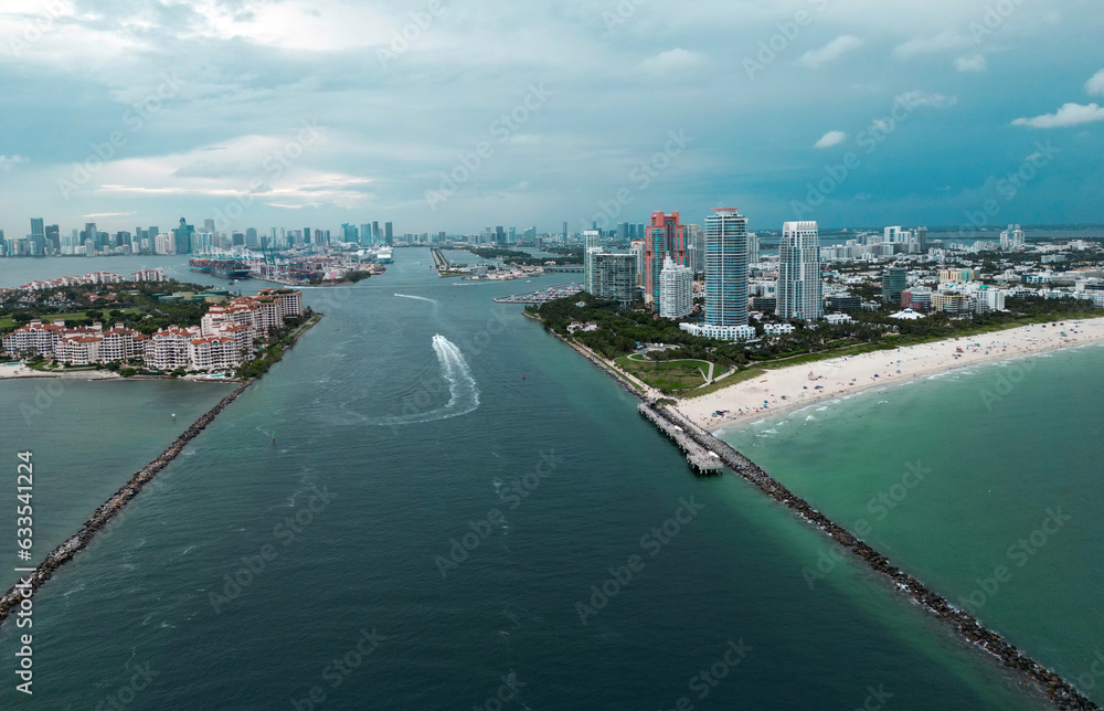 Fisher Island skyline with buildings seen from bay in South Beach. Miami Beach and Fisher Island aerial view. Luxury apartments on Fisher Island. Fisher Island from South Point Park Miami. Fisher Island skyline with buildings seen from bay in South Beach. Miami Beach and Fisher Island aerial view. Luxury apartments on Fisher Island. Fisher Island from South Point Park Miami.