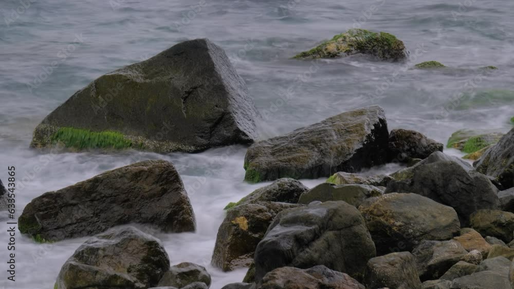 Timelapse: water waves of the Black Sea are moving fast, crashing on rocks on the stony shore, coast - close up, nobody, no people. Nature, element, landscape, abstract and time lapse concept Timelapse: water waves of the Black Sea are moving fast, crashing on rocks on the stony shore, coast - close up, nobody, no people. Nature, element, landscape, abstract and time lapse concept