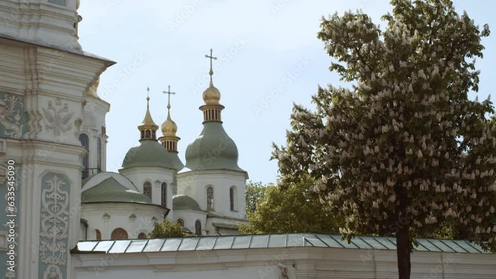 View of the 11th century church - Saint Sophia cathedral on Kyiv. Beautiful flowering chestnuts View of the 11th century church - Saint Sophia cathedral on Kyiv. Beautiful flowering chestnuts
