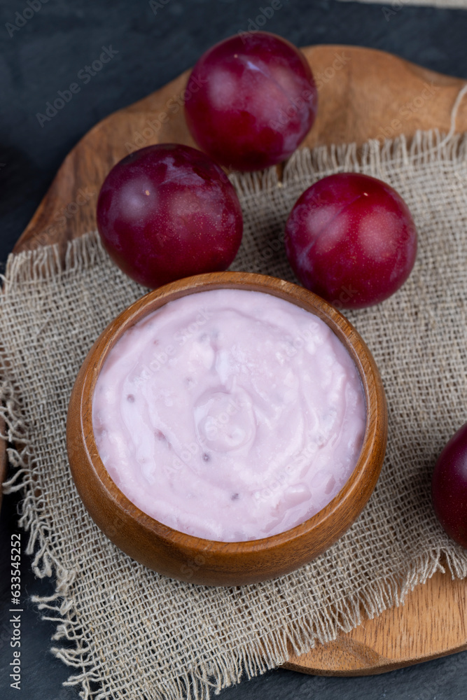 flavored pink yogurt with ripe and sweet plum flavored pink yogurt with ripe and sweet plum