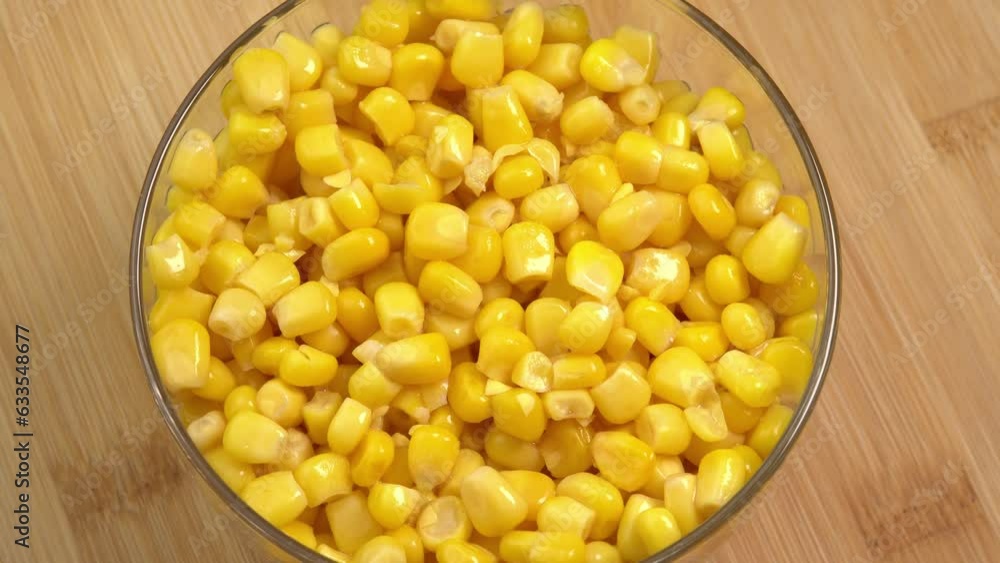 Sweet corn kernels rotate in glass bowl. Ingredient for mexican salad filled with vitamins Sweet corn kernels rotate in glass bowl. Ingredient for mexican salad filled with vitamins