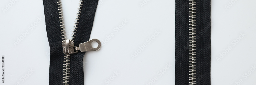 Zipped and unzipped metallic zipper lock on white background. Zipped and unzipped metallic zipper lock on white background.