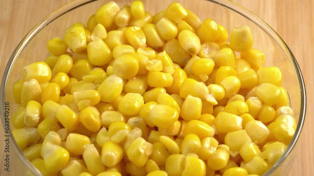 Sweet corn kernels rotate in glass bowl. Ingredient for mexican salad filled with vitamins Sweet corn kernels rotate in glass bowl. Ingredient for mexican salad filled with vitamins